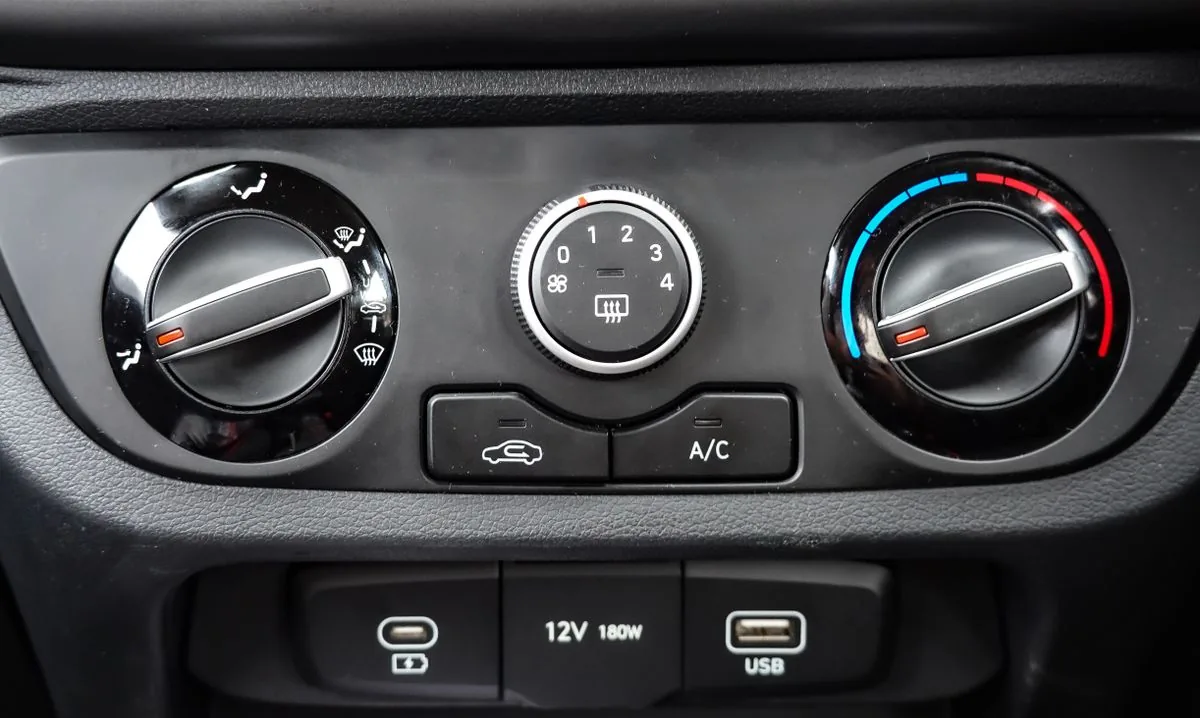 Controles del aire acondicionado de un automóvil. Imagen de referencia para una marca ficticia.