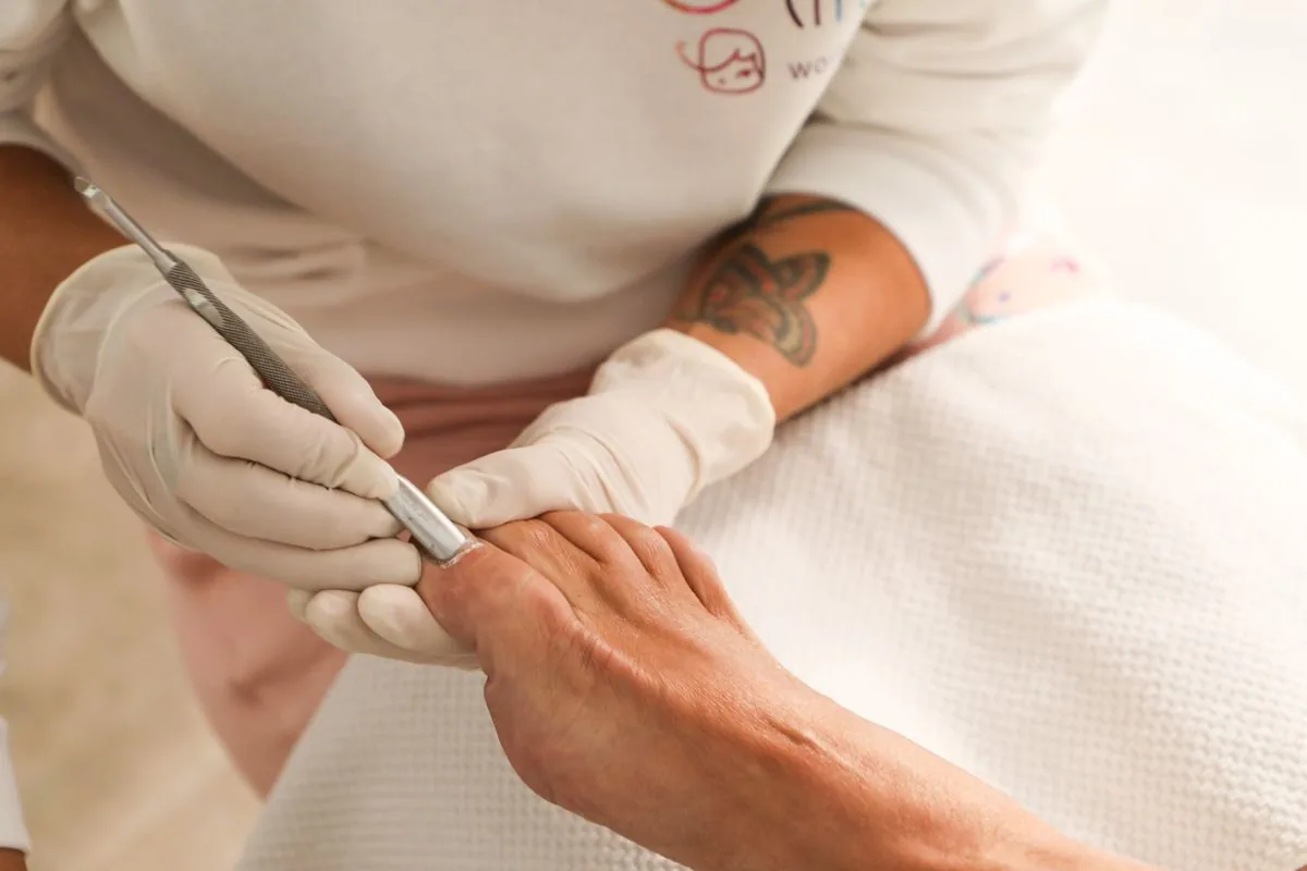Aplicación de manicura con herramientas de salón. Imagen de referencia para una marca ficticia.