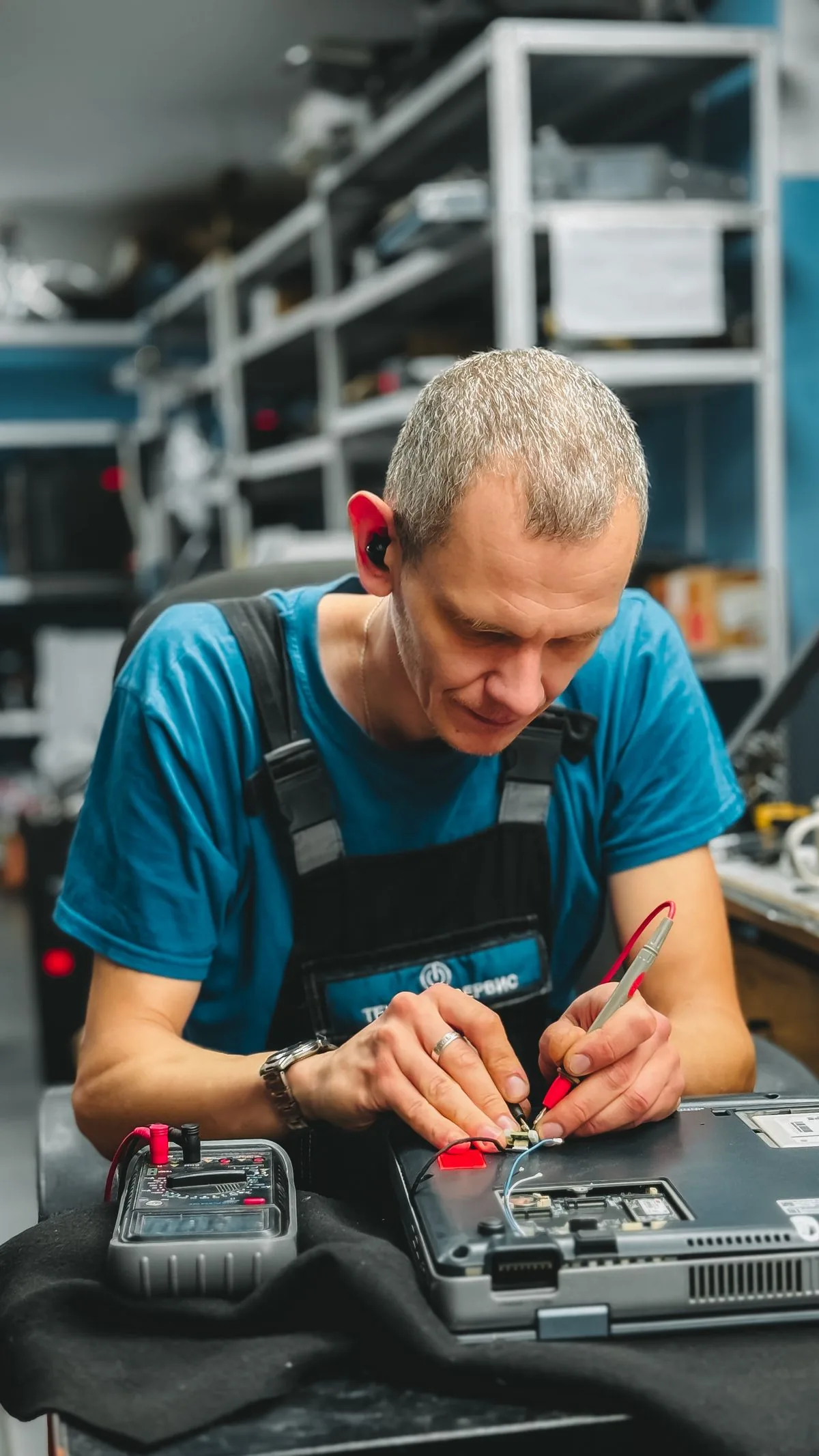 Técnico reparando una computadora portátil. Imagen de referencia para una marca ficticia.